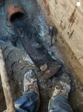 Excavated private sewer line prepared for repair