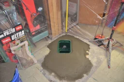 Completed backwater valve access installed in a basement floor