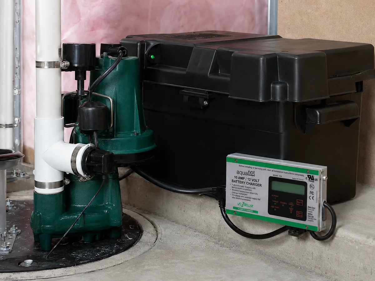 Sump pump and battery backup system installed in a basement.